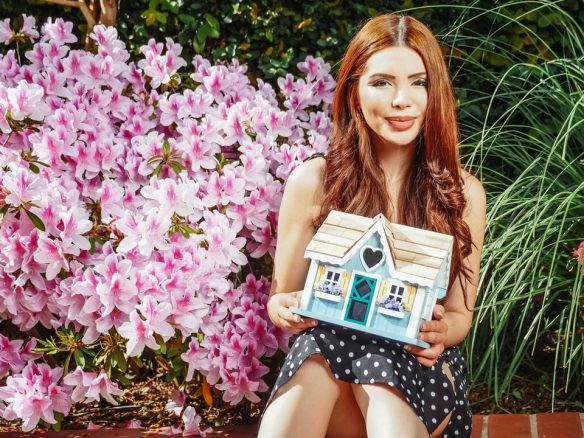Woman holding a little house
